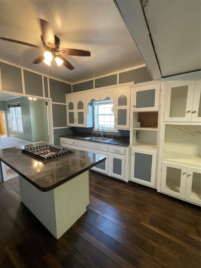 kitchen featuring white cabinets, stainless steel gas stovetop, and sink