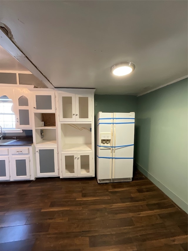 kitchen featuring white cabinets, dark hardwood / wood-style floors, white fridge with ice dispenser, and sink