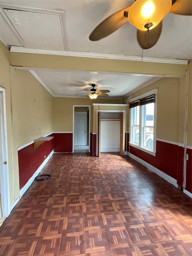 interior space with dark parquet floors, ornamental molding, and a textured ceiling