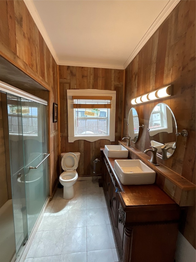 bathroom with crown molding, a shower with door, vanity, and wood walls