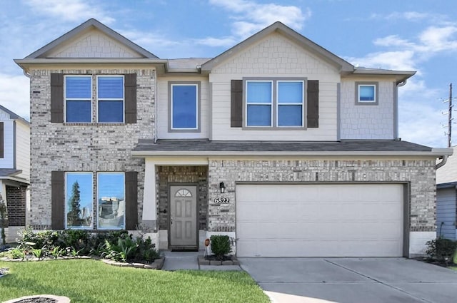 view of front of property with a front lawn and a garage