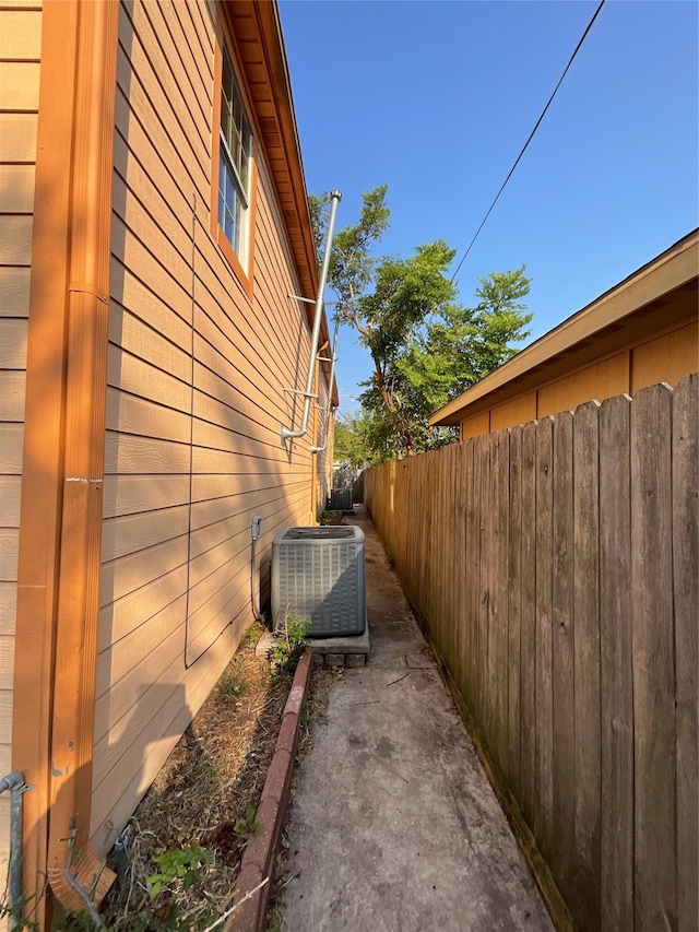 view of side of home with central air condition unit