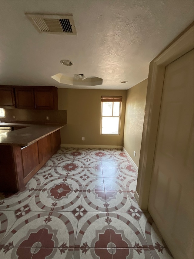 kitchen featuring light tile patterned floors and a textured ceiling