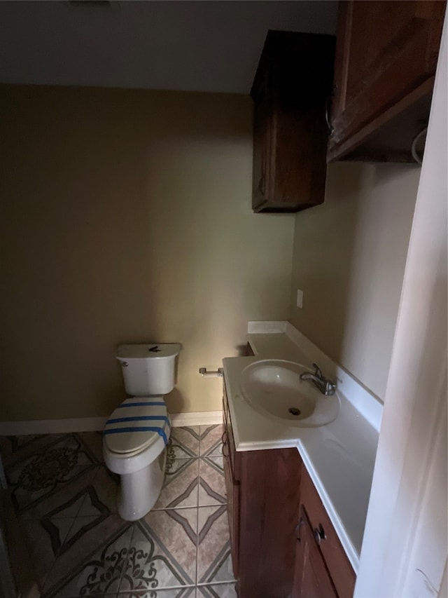 bathroom featuring tile patterned flooring, vanity, and toilet