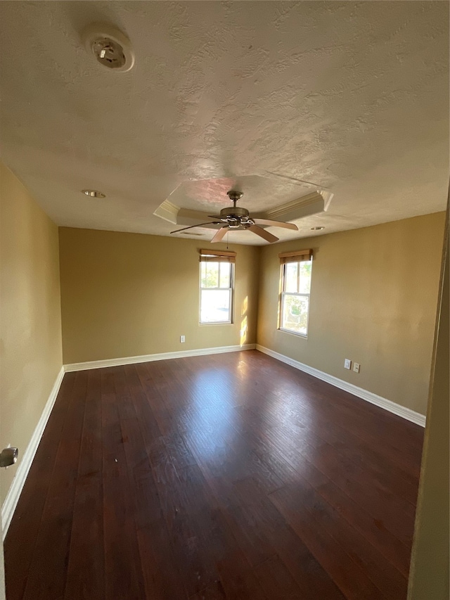 spare room with dark wood-type flooring and a textured ceiling