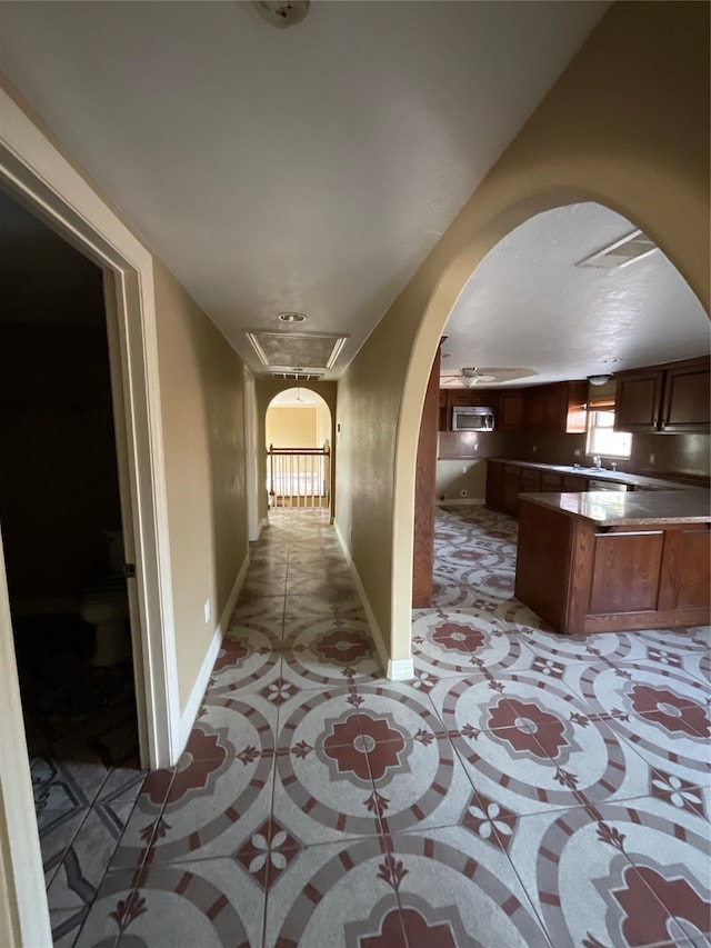 corridor with light tile patterned floors