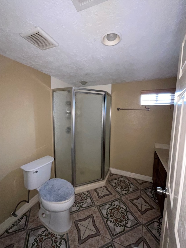 bathroom with tile patterned flooring, vanity, toilet, and an enclosed shower