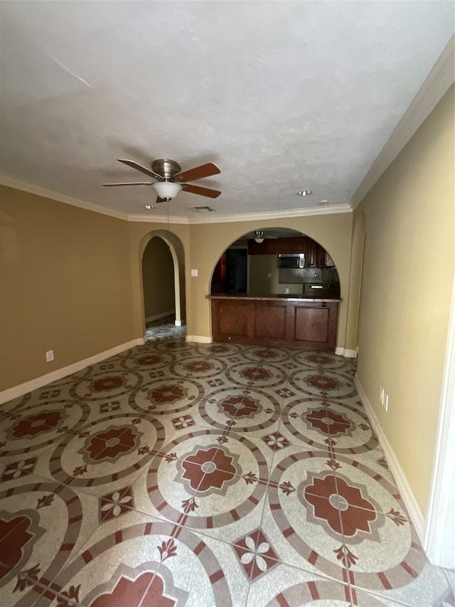 unfurnished living room featuring ceiling fan and ornamental molding