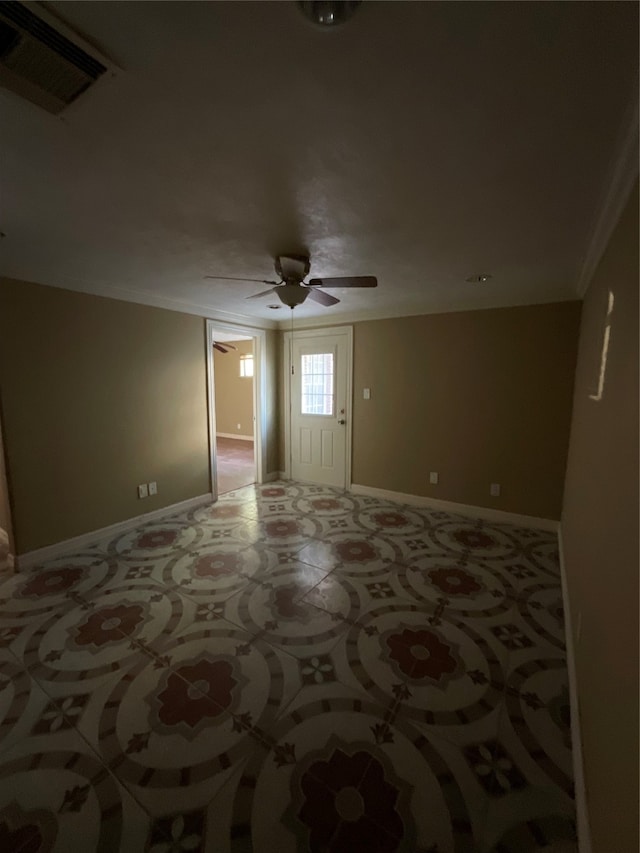 spare room with ceiling fan and ornamental molding