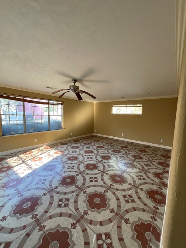 spare room featuring ceiling fan, plenty of natural light, and ornamental molding