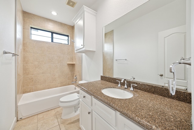 full bathroom with tile patterned flooring, vanity, tiled shower / bath combo, and toilet