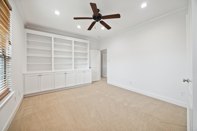 unfurnished bedroom featuring crown molding, ceiling fan, and light colored carpet