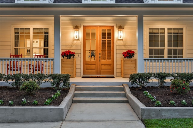 view of exterior entry with a porch