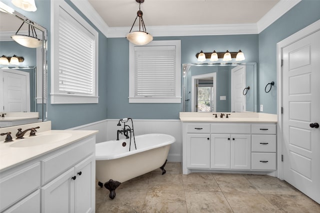 bathroom with crown molding, a bathtub, and vanity