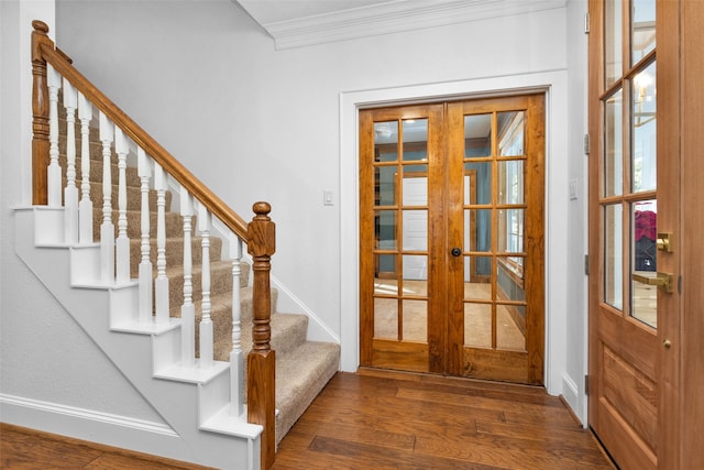 doorway featuring dark hardwood / wood-style flooring, ornamental molding, and french doors