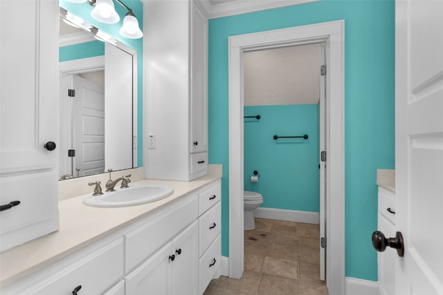 bathroom with vanity, toilet, and ornamental molding