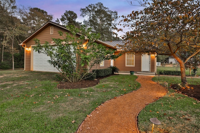 view of front of property with a lawn and a garage