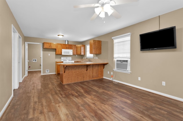 kitchen featuring range, cooling unit, dark hardwood / wood-style floors, ceiling fan, and kitchen peninsula