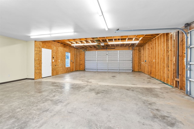 garage featuring wood walls