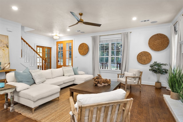 living room with ceiling fan, dark hardwood / wood-style flooring, ornamental molding, and french doors