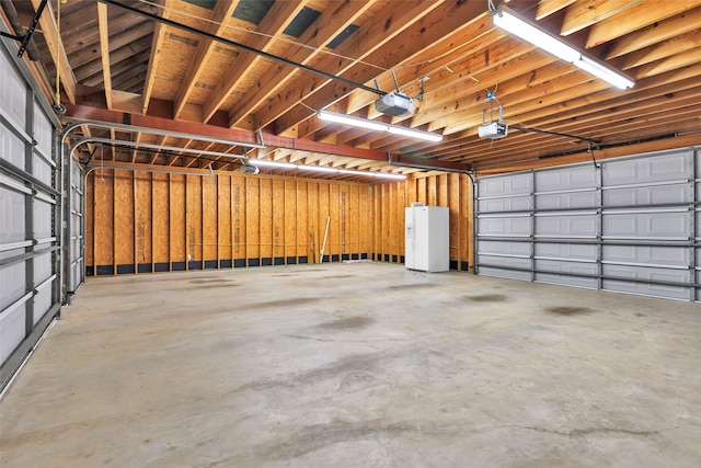 garage with white refrigerator with ice dispenser and a garage door opener