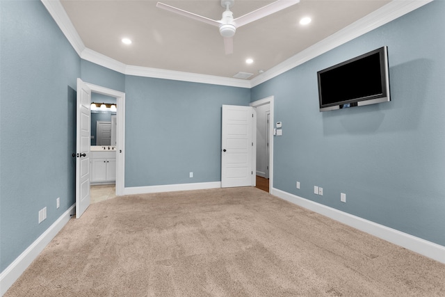 unfurnished bedroom featuring ceiling fan, crown molding, light colored carpet, and ensuite bathroom