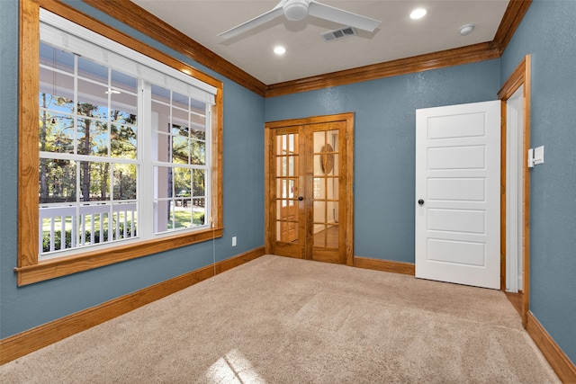 unfurnished room with carpet flooring, ceiling fan, crown molding, and french doors