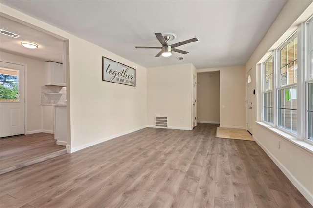 unfurnished living room with ceiling fan and light hardwood / wood-style floors