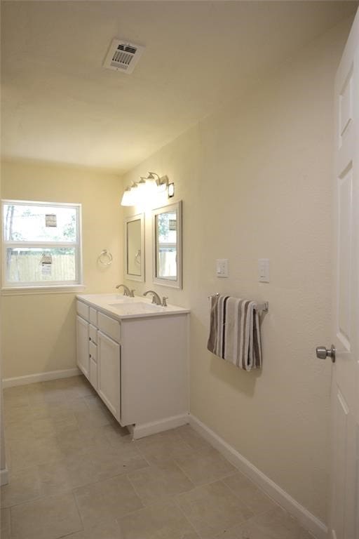 bathroom with tile patterned flooring and vanity