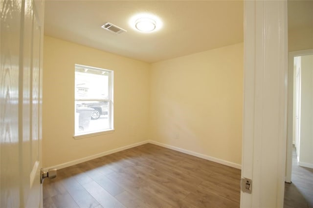 empty room with dark hardwood / wood-style floors