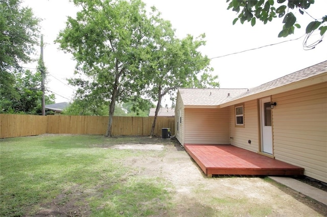 view of yard with central air condition unit and a deck