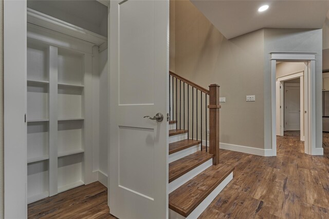 stairway featuring recessed lighting, baseboards, and wood finished floors