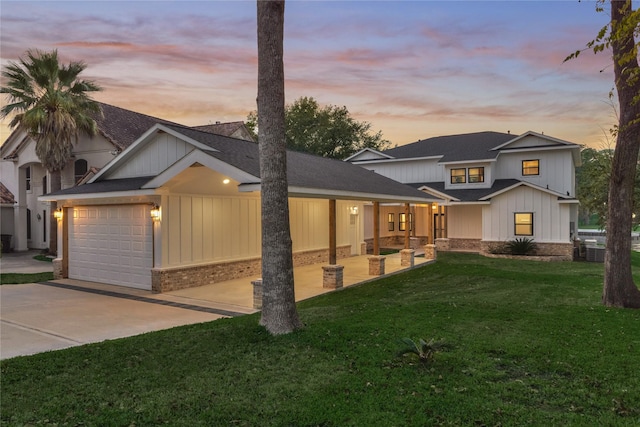 modern farmhouse style home featuring board and batten siding, a front lawn, a garage, and concrete driveway