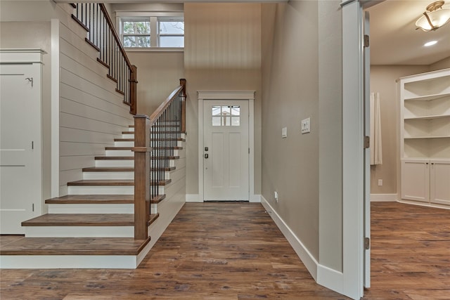 entryway with stairs, recessed lighting, wood finished floors, and baseboards