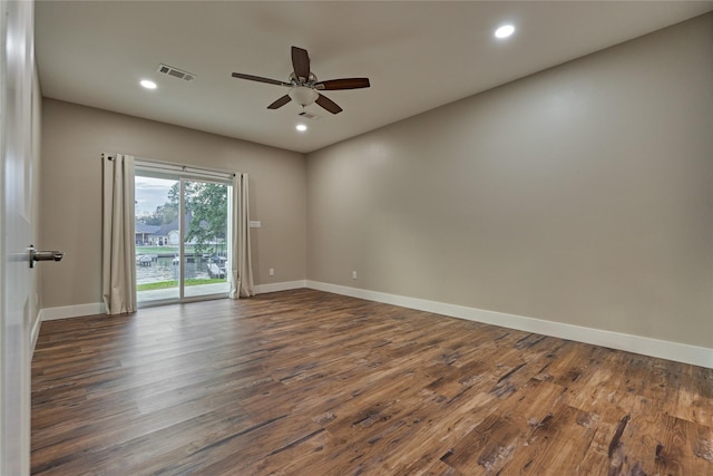 unfurnished room with visible vents, recessed lighting, baseboards, and dark wood-style flooring