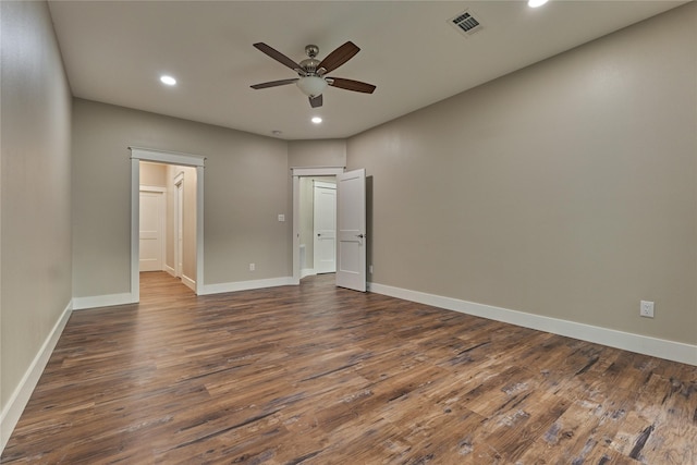 unfurnished bedroom with visible vents, baseboards, and dark wood-style flooring