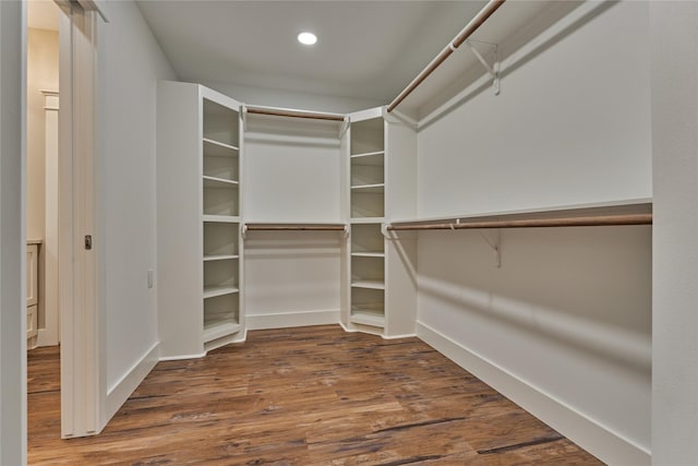 walk in closet with wood finished floors