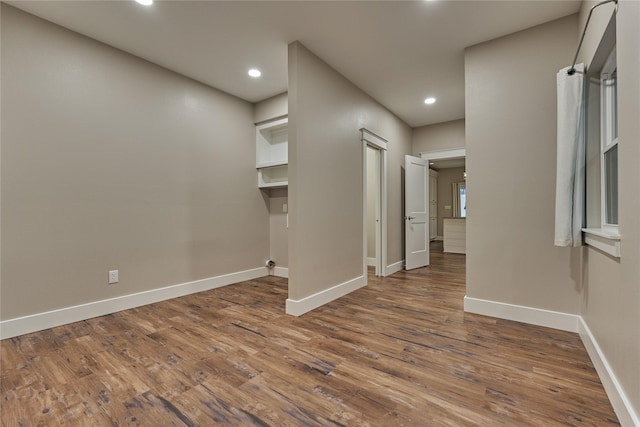 interior space with recessed lighting, wood finished floors, and baseboards