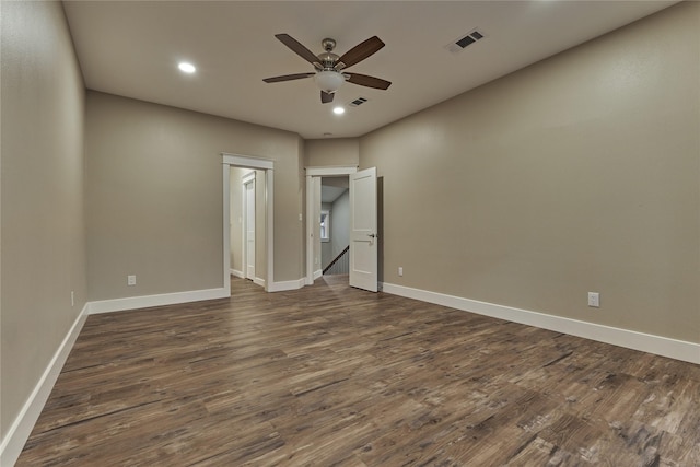 unfurnished bedroom with dark wood finished floors, baseboards, and visible vents