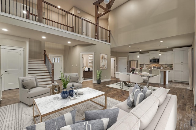 living area featuring dark wood finished floors, stairs, recessed lighting, and baseboards