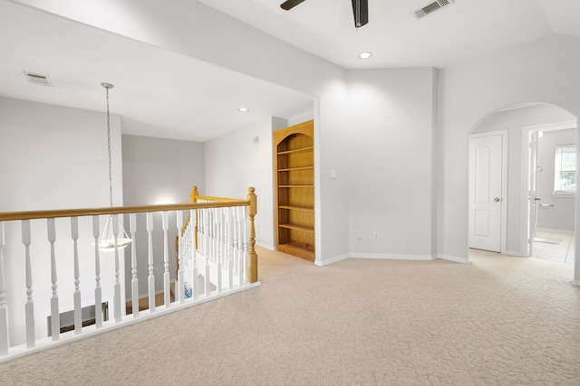 carpeted spare room with ceiling fan and lofted ceiling