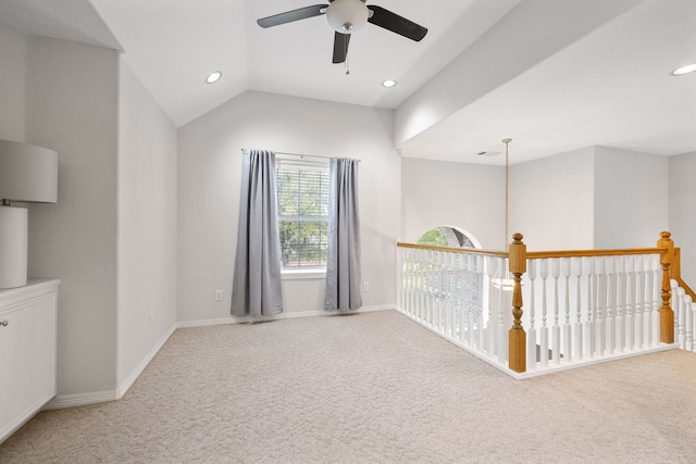 carpeted empty room with ceiling fan and lofted ceiling