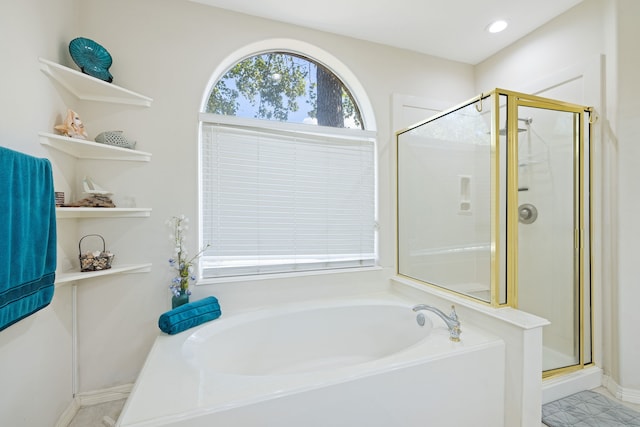 bathroom featuring independent shower and bath