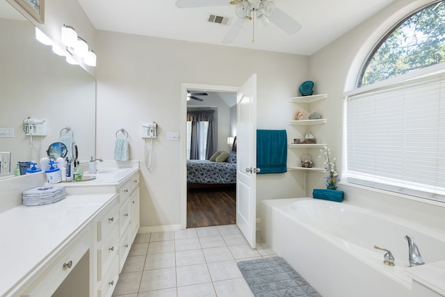 bathroom with tile patterned floors, vanity, and a bathing tub