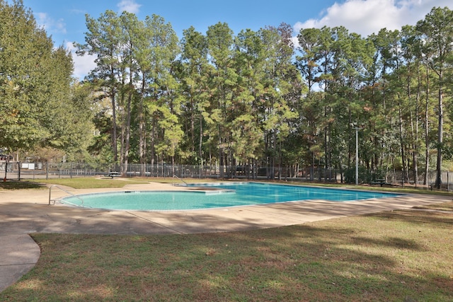 view of pool featuring a yard and a patio