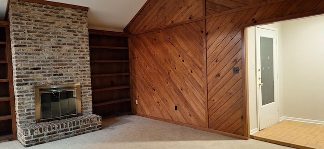 12 Windsor Ct, Lufkin, TX 75901 - unfurnished living room featuring baseboards, a fireplace, wood walls, and lofted ceiling