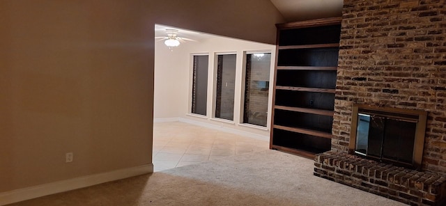 unfurnished living room featuring ceiling fan, light tile patterned flooring, lofted ceiling, and a brick fireplace