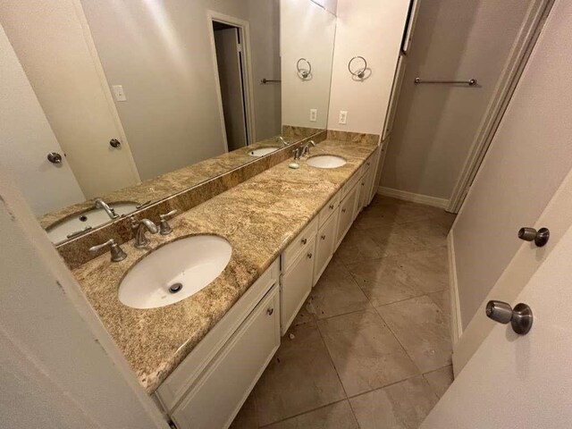 12 Windsor Ct, Lufkin, TX 75901 - bathroom featuring double vanity, tile patterned flooring, and baseboards