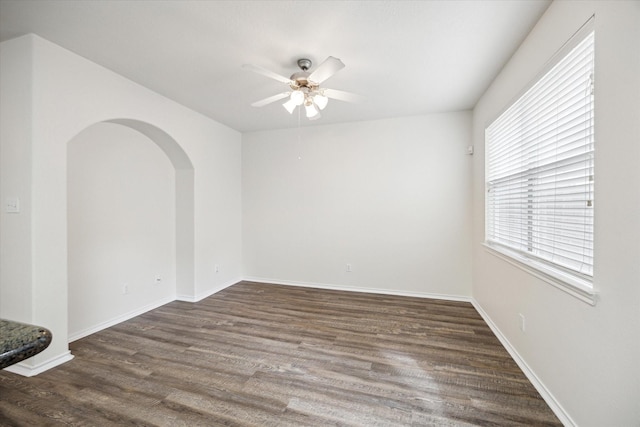 empty room featuring ceiling fan and dark hardwood / wood-style flooring