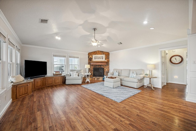 unfurnished living room with dark wood-type flooring, a stone fireplace, crown molding, ceiling fan, and a textured ceiling